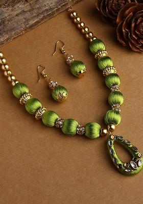 Gold Plated White And Green Stone Studded And Beaded Wooden Balls Silk Thread Jewellery Set
