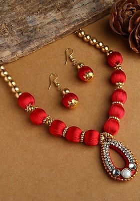 Gold Plated White And Red Stones Studded And Beaded Wooden Balls Silk Thread Jewellery Set