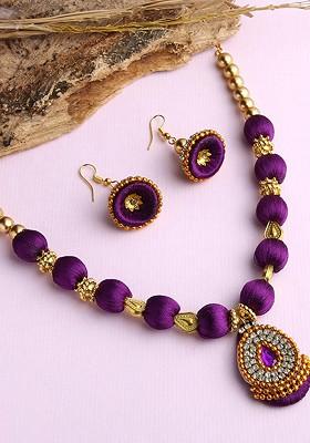 Gold Plated White And Purple Stones Studded And Beaded Wooden Balls Silk Thread Jewellery Set