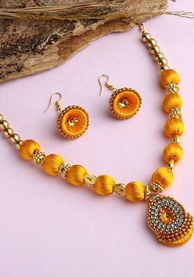 Gold Plated White And Yellow Stones Studded And Beaded Wooden Balls Silk Thread Jewellery Set