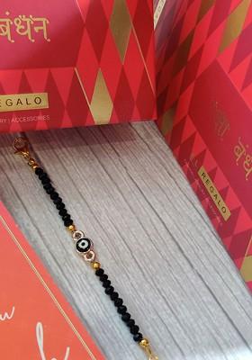 Gold Coloured Black Evil Eye Baby Rakhi With Raksha Bandhan Greeting Card