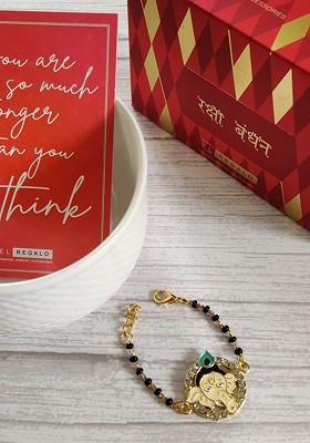Baby Goldtoned Nazaria Rakhi Combo With Greeting Card Roli Chawal Shagun