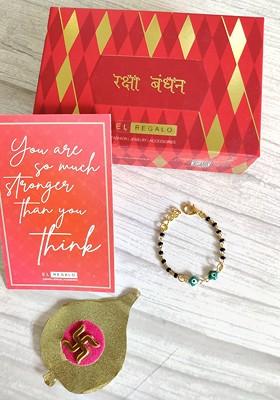 Baby Goldtoned Nazaria Rakhi Combo With Greeting Card And Roli Chawal Shagun