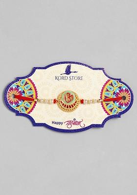 Red Red And Green Enamelled Om Ruby Stoned Thread Rakhi