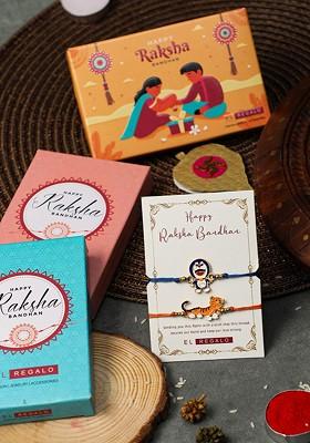 Blue Boys Set Of 2 Tiger And Doreman Thread Rakhis With Roli Chawal And Greeting Card