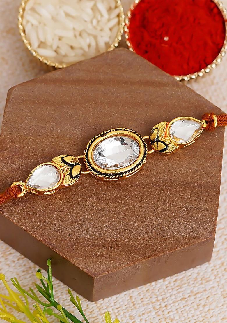 White And Gold Toned Kundan Studded Rakhi