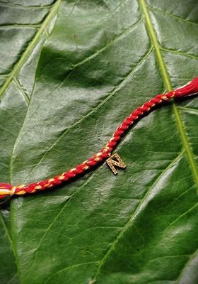 Gold Plated Red And Yellow Ad Studded N Alphabet Customized Thread Rakhi