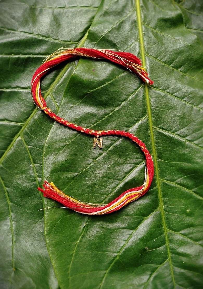 Gold Plated Red And Yellow Ad Studded N Alphabet Customized Thread Rakhi - Indya