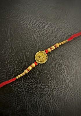 Red And Gold Toned Beaded Rakhi With Om Pendant