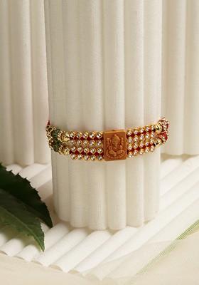 Gold Toned Stone Studded Ganpati Mauli Rakhi With Roli Chawal