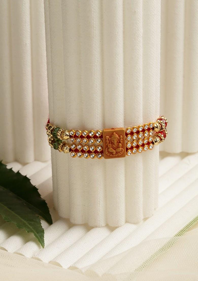 Gold Toned Stone Studded Ganpati Mauli Rakhi With Roli Chawal - Indya