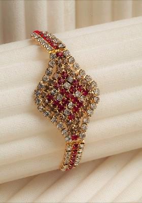 Gold Toned And Red Ad Stoned Studded Swastik Rakhi With Roli Chawal