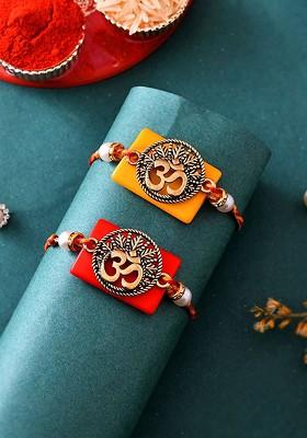 Gold Toned Set Of 2 Om Charm Thread Rakhis With Roli Chawal And Greeting Card