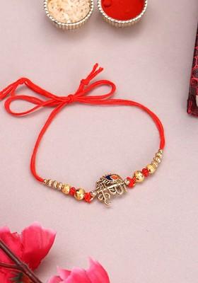 Gold Plated Name Of Krishna Shaped Stone Studded Rakhi With Roli Chawal
