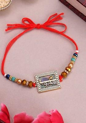 Gold Plated Name Of Krishna Shaped Stone Studded Rakhi With Roli Chawal