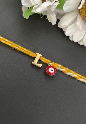 Gold Plated L Alphabet And Evil Eye Charm Rakhi