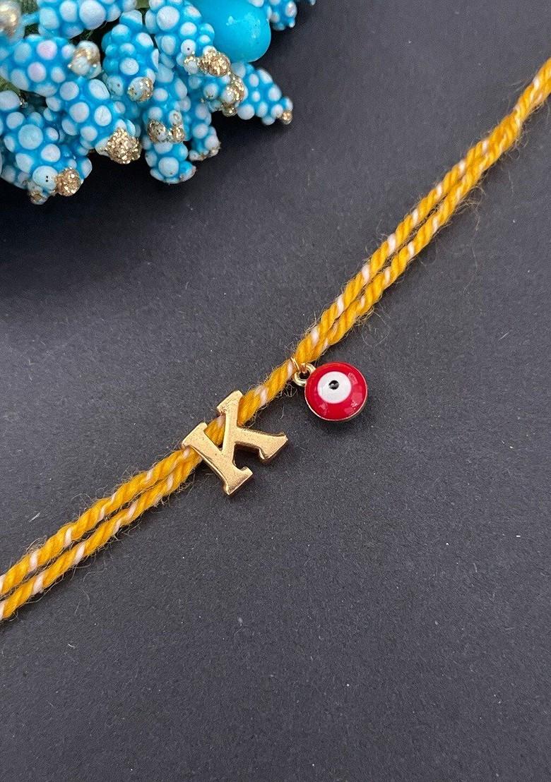 Gold Plated K Alphabet And Evil Eye Charm Rakhi - Indya
