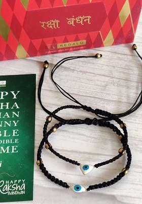 Set Of 2 Black Rakhis With Roli Chawal And Greetings Card