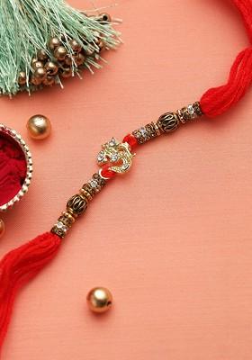 Gold Toned And Red Om Studded Thread Rakhi