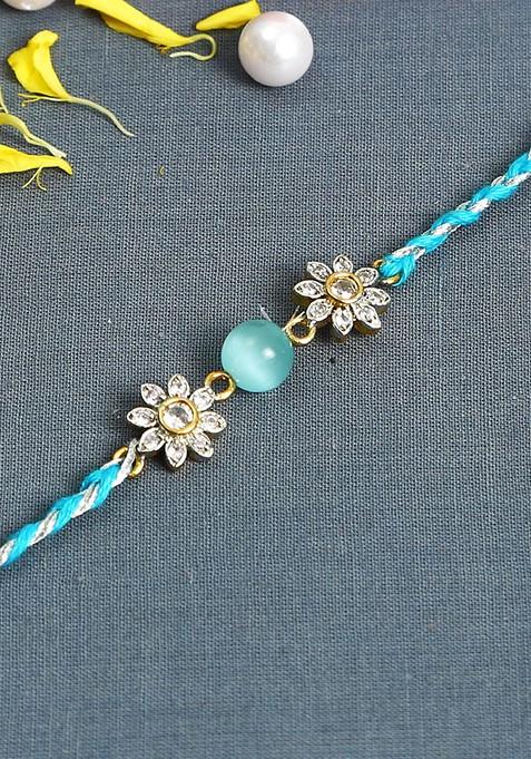 Turquoise Blue Floral Ad Studded Rakhi With Roli Chawal And Card