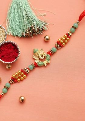 Gold Toned And Red Meenakari Work Ganapati Beaded Rakhi