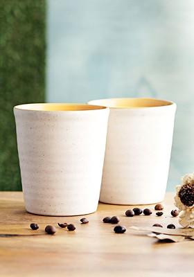 Off White And Peach Coloured 2 Pieces Solid Ceramic Cups And Saucers Set