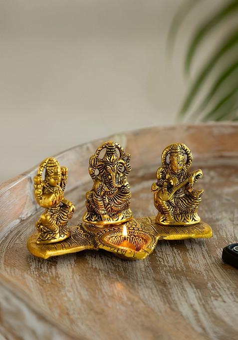Gold Toned Laxmi Ganesh And Saraswati Idol And Diya Decorative Figurines
