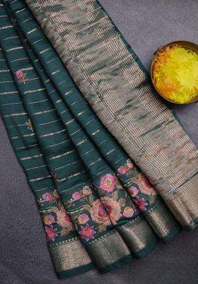 Assam Silk Saree Bottle Green With Allover Zari Weaves Floral Embroidery Work Buttas And Zari Woven Border With Embroidered Design For Women