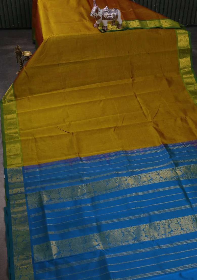 Silk Cotton Saree Dark Mustard And Dual Shade Of Bluish Green With Plain Body And Peacock Zari Woven Border With Traditional Woven Design For Women - Indya