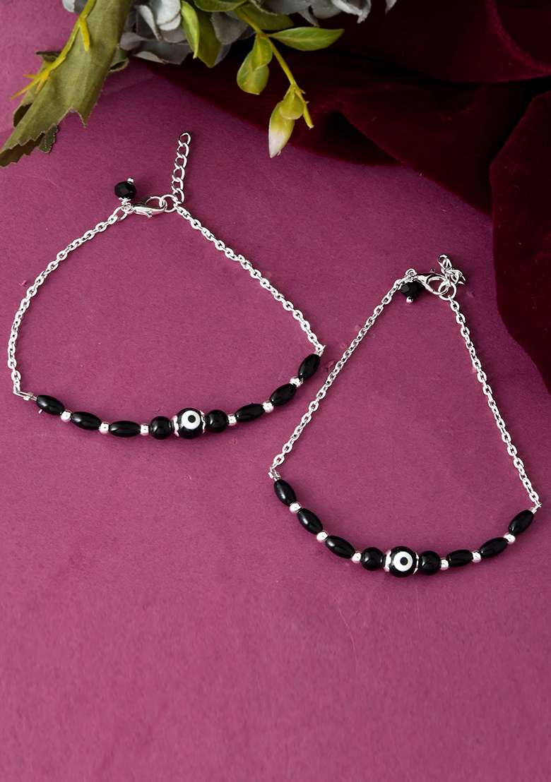 Set Of 2 Silver And Plated Stainless Steel Beaded Anklets With Artificial Black Stones And Floral Charms

 - Indya