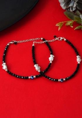 Set Of 2 Black Beaded Evil Eye Anklets With Silver And Toned Shell Charms

