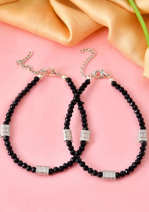 Set Of 2 Silver And Plated Anklets With Polished Black Beads And Barrel Charms

