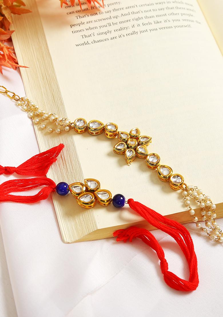 Set Of 2 Gold Toned Kundan Embellished Rakhi And Floral Lumba Set 