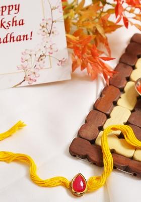 Red Gold Tone Kundan Rakhi With Yellow Thread