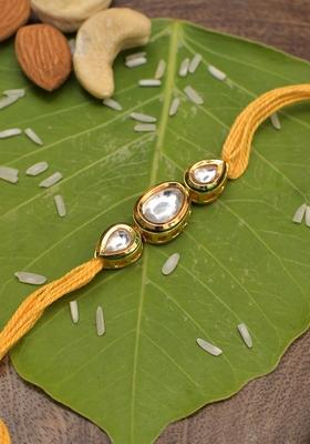 Gold Tone Kundan Rakhi With Yellow Cotton Thread