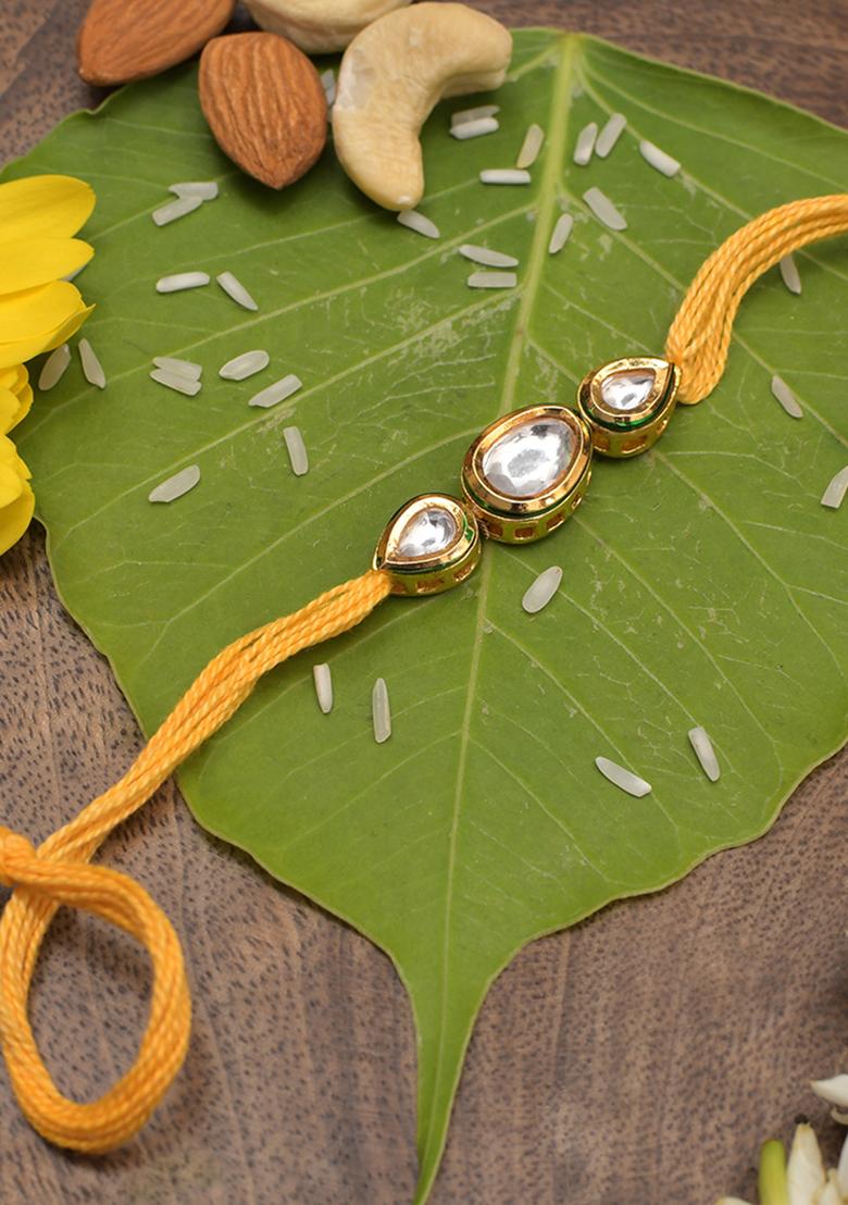 Gold Tone Kundan Rakhi With Yellow Cotton Thread
