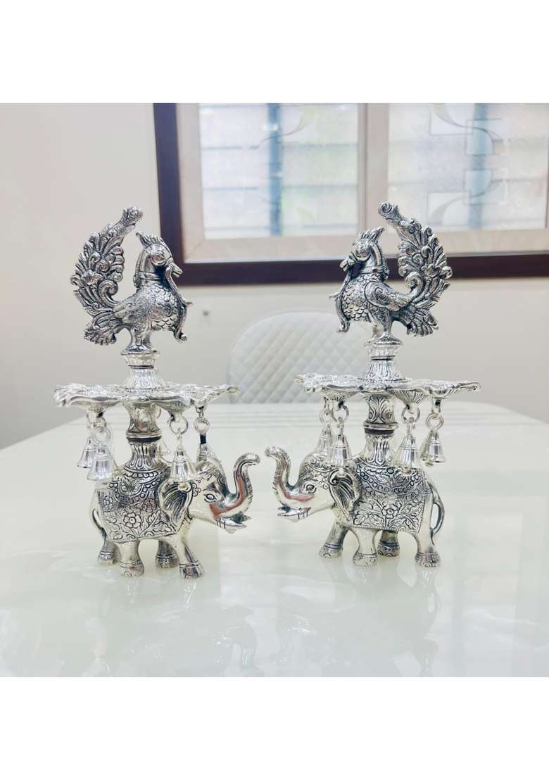 Mishita Collections German Silver Peacock Samai Pair Diya Stand with Elephant Base and Plate Pack of 2 - Indya