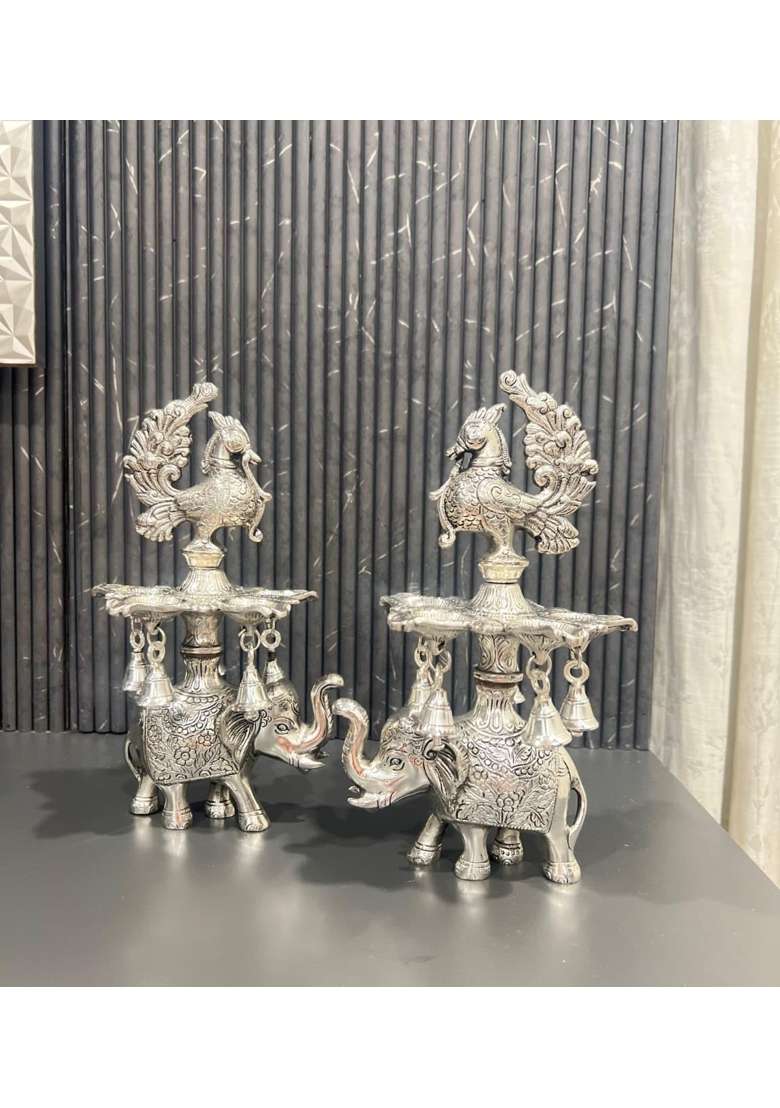 Mishita Collections German Silver Peacock Samai Pair Diya Stand with Elephant Base and Plate Pack of 2 - Indya