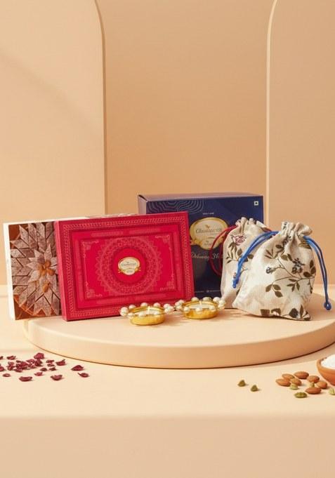 Ghasitaram Diwali Gifts-Blue Box Of Kaju Katli, Milk Cake, Almonds And Flavour Raisins In Jute Pouch...