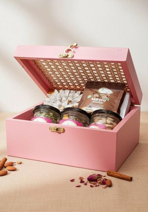 Ghasitaram Diwali Gifts-Pink Cane Rattan Box With Kaju Katli, Paan Raisins, Crunchy Cashew, Pista And Mewa...