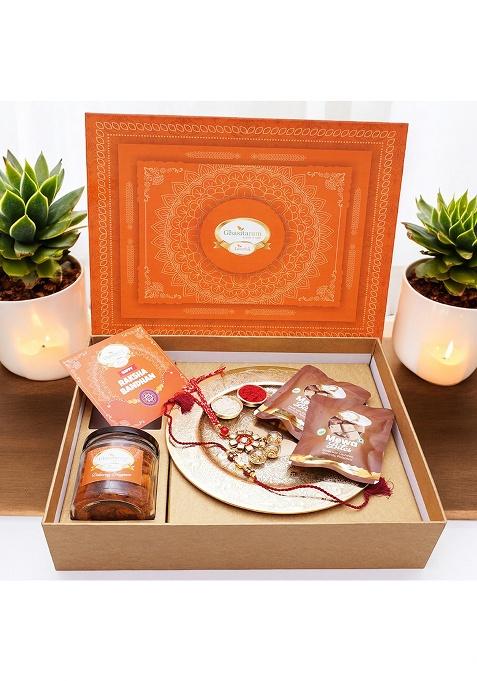 Jaiccha Ghasitaram Gifts Rakhi For Brothers Orange Hamper Box With Gold Pooja Thali, Bhaiya Bhabhi Rakhis, Card, Mewa Bites Pouches And Mixed Dryfruit Jar